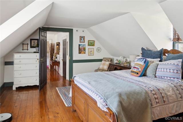 bedroom featuring vaulted ceiling and dark wood-type flooring