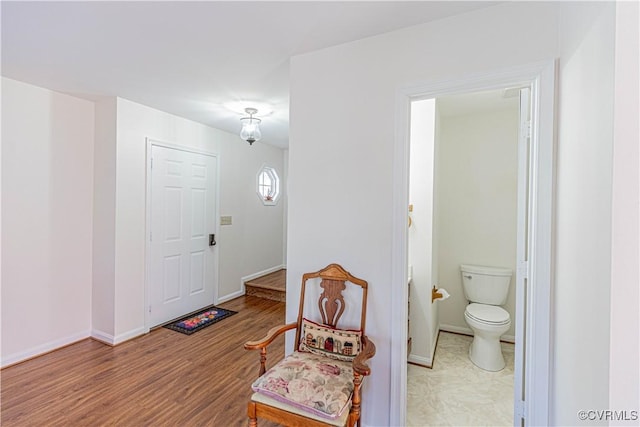 entryway featuring wood finished floors and baseboards