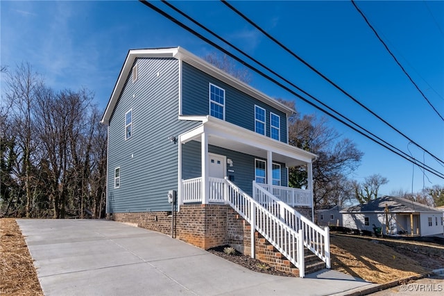 view of front of home featuring a porch and stairway