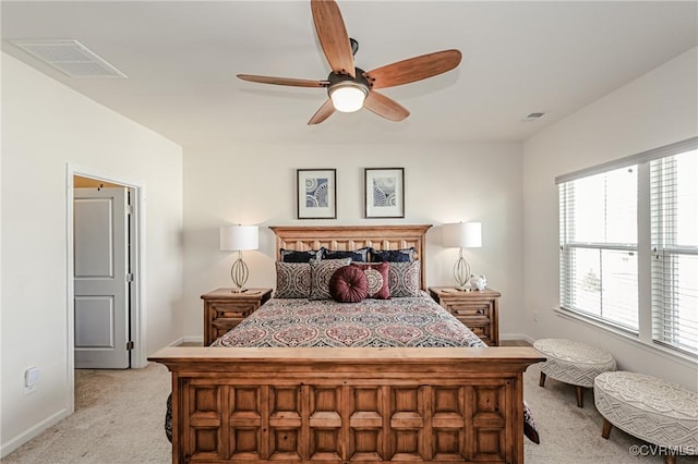 carpeted bedroom with a ceiling fan, visible vents, and baseboards