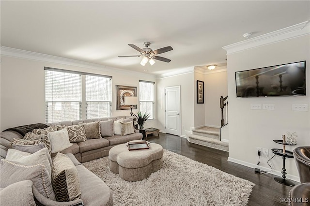 living room with dark wood finished floors, crown molding, baseboards, and stairs