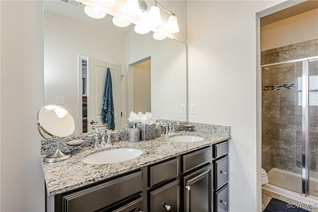 bathroom with a notable chandelier, a sink, and a shower stall