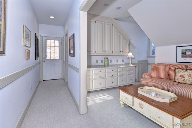 living area featuring light carpet, lofted ceiling, baseboards, and recessed lighting