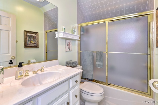 full bathroom featuring toilet, combined bath / shower with glass door, and vanity