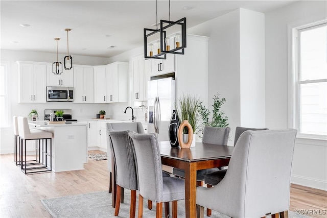 dining space featuring light wood-style flooring