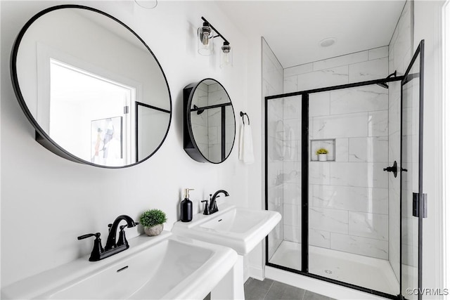 bathroom featuring a stall shower and a sink