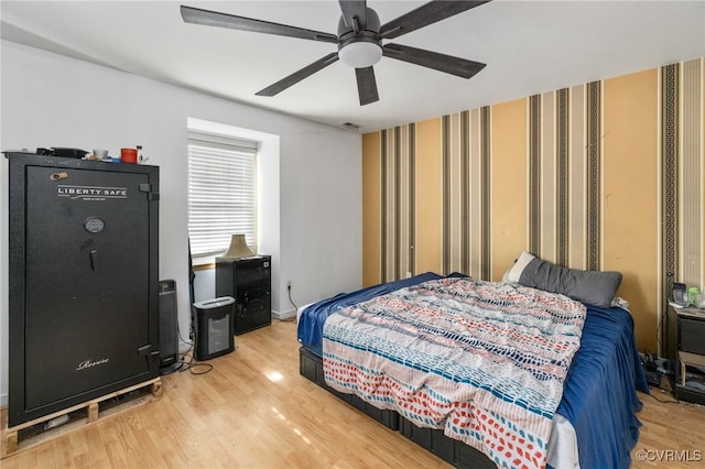 bedroom with a ceiling fan and wood finished floors