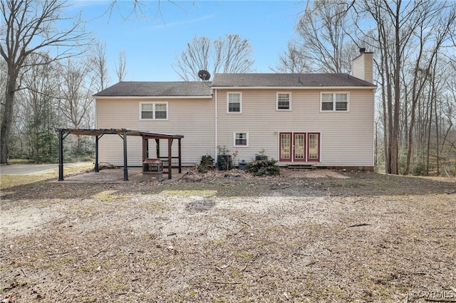 back of house with a patio area, a chimney, and a pergola