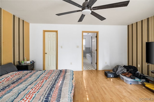 bedroom with wallpapered walls, ceiling fan, baseboards, and wood finished floors