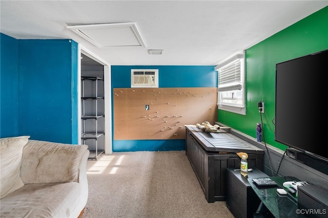 miscellaneous room with attic access, light colored carpet, and a wall unit AC