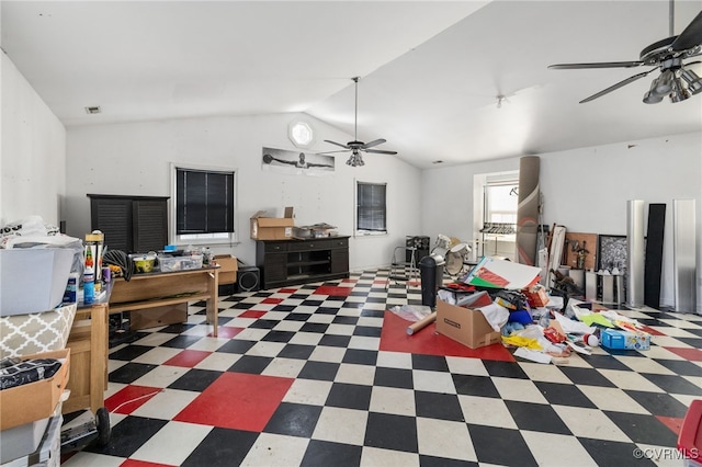 recreation room featuring lofted ceiling, dark floors, and ceiling fan