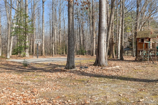 view of yard with playground community and community basketball court