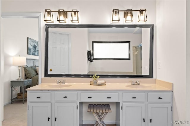 ensuite bathroom featuring double vanity, a sink, a shower with shower door, and connected bathroom