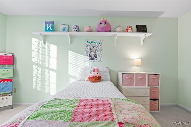 bedroom featuring light carpet and baseboards