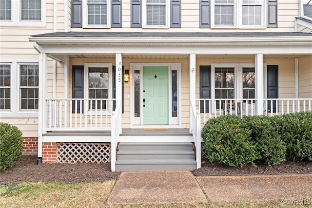 view of exterior entry featuring a porch