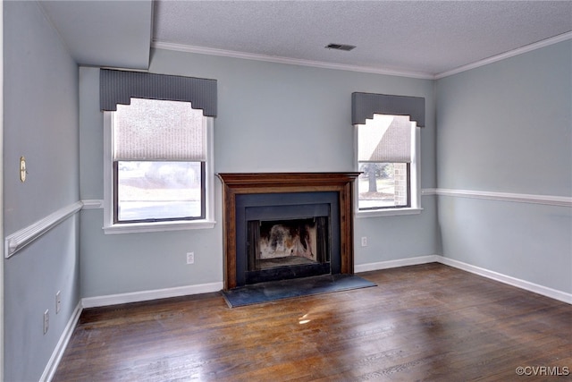 unfurnished living room with a fireplace with raised hearth, dark wood-type flooring, visible vents, and crown molding