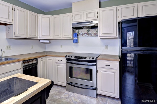 kitchen featuring stainless steel electric range oven, freestanding refrigerator, white cabinets, and under cabinet range hood