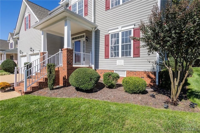 exterior space featuring covered porch and a yard