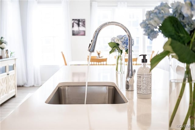 room details featuring light countertops and a sink