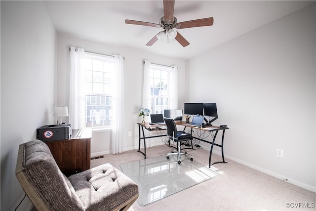 office space featuring ceiling fan, light carpet, visible vents, and baseboards