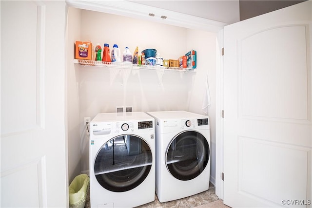 washroom with laundry area and washing machine and dryer