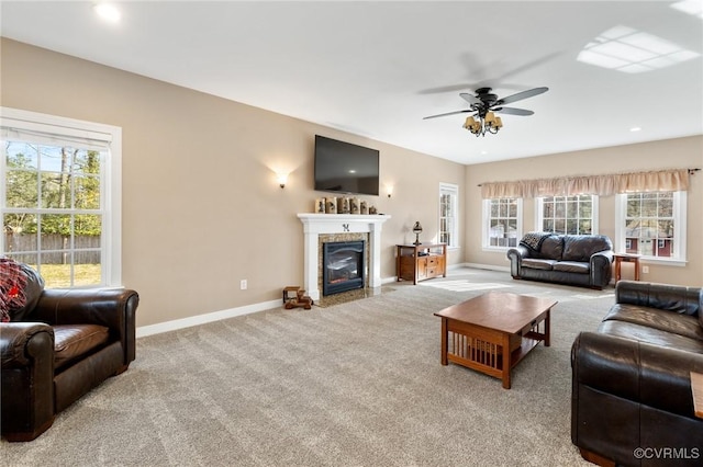 living area with a high end fireplace, recessed lighting, carpet, baseboards, and ceiling fan