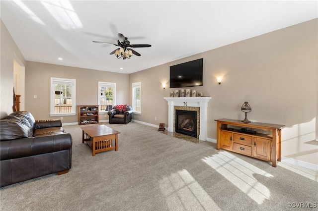 living room with a high end fireplace, recessed lighting, carpet floors, baseboards, and ceiling fan