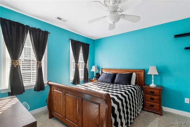 bedroom featuring visible vents, multiple windows, and light colored carpet