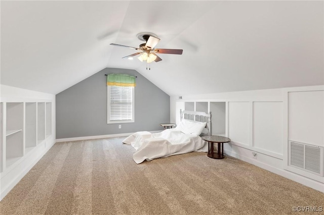 unfurnished bedroom featuring visible vents, a ceiling fan, carpet flooring, and vaulted ceiling