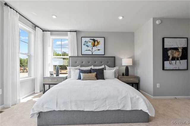 bedroom with baseboards, recessed lighting, and light colored carpet