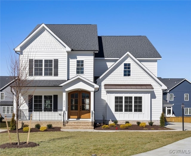 view of front of house featuring a standing seam roof, a shingled roof, a front lawn, and french doors