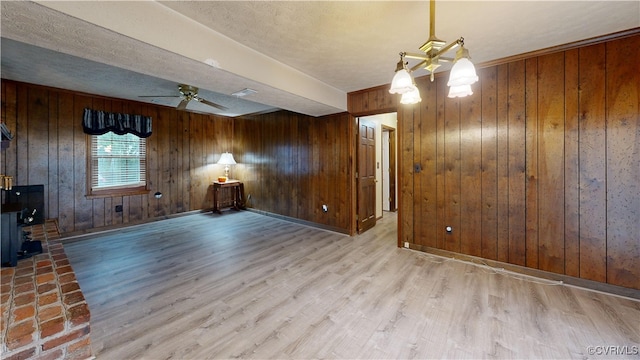 unfurnished living room with a ceiling fan, visible vents, light wood-style flooring, and baseboards