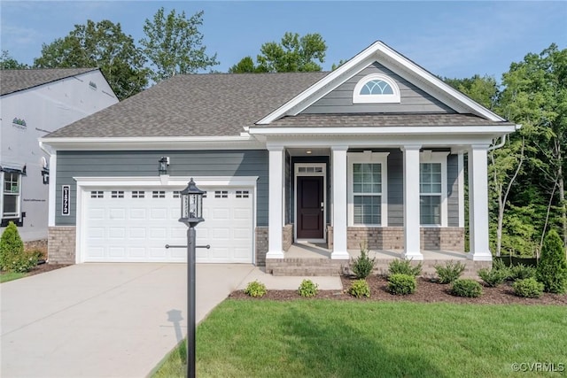 view of front of house with a shingled roof, concrete driveway, an attached garage, covered porch, and a front lawn