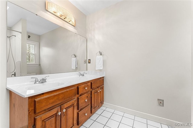 full bath featuring a sink, curtained shower, tile patterned flooring, double vanity, and baseboards