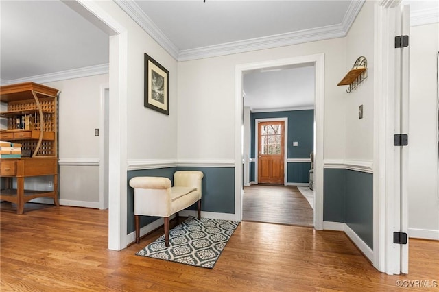 entryway with crown molding, wood finished floors, and baseboards