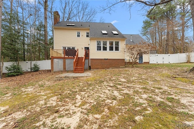 back of property featuring stairs, a wooden deck, a fenced backyard, and a chimney