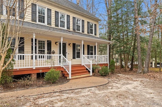 view of front of property with a porch and a shingled roof