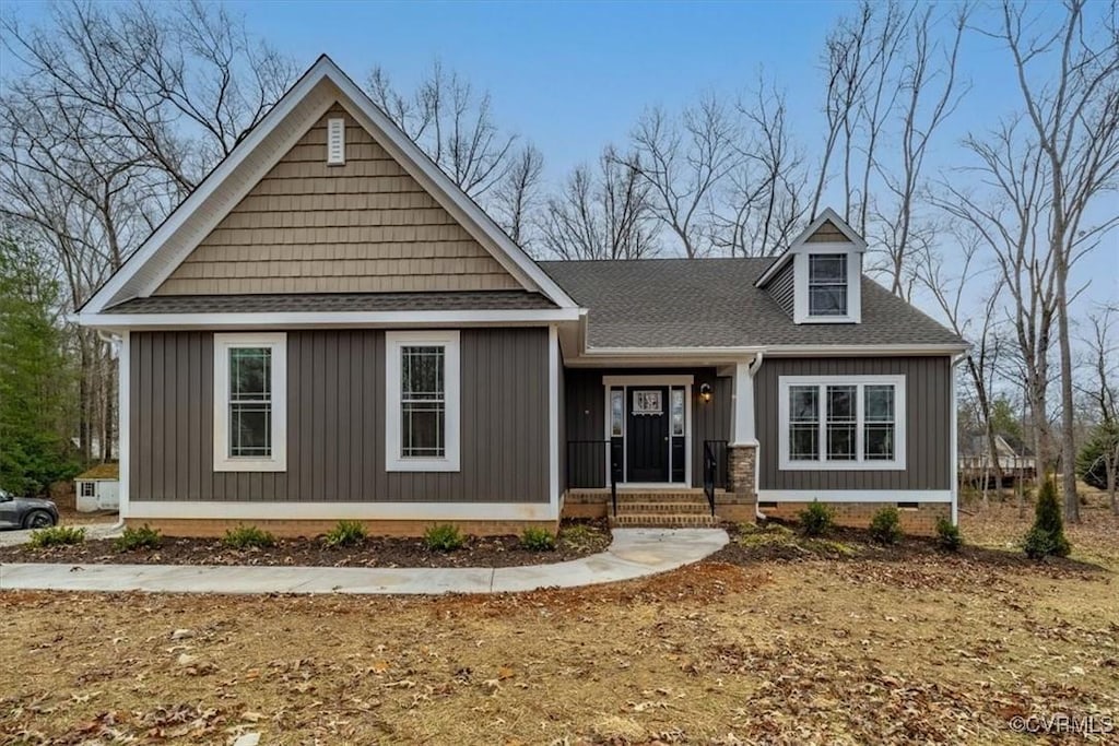 view of front of home featuring crawl space and roof with shingles