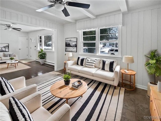 living room with ceiling fan, a baseboard heating unit, wood finished floors, baseboards, and beam ceiling