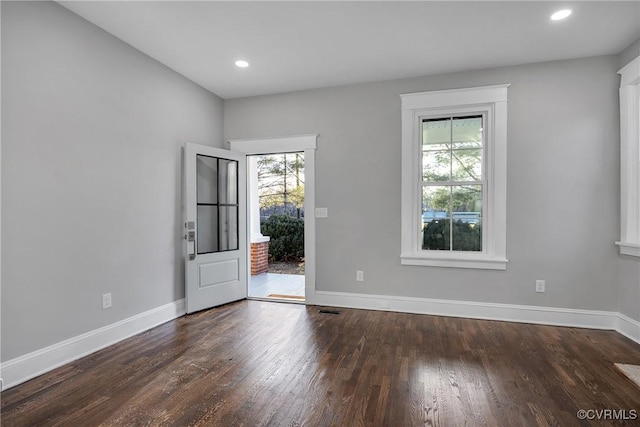 spare room with recessed lighting, wood finished floors, and baseboards