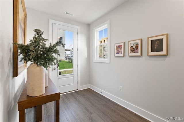 entryway featuring dark wood-style floors, visible vents, and baseboards