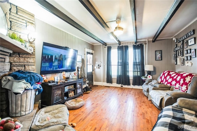 living room featuring beamed ceiling and wood finished floors