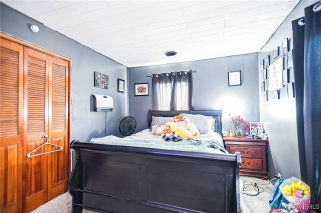 bedroom featuring a closet and light colored carpet