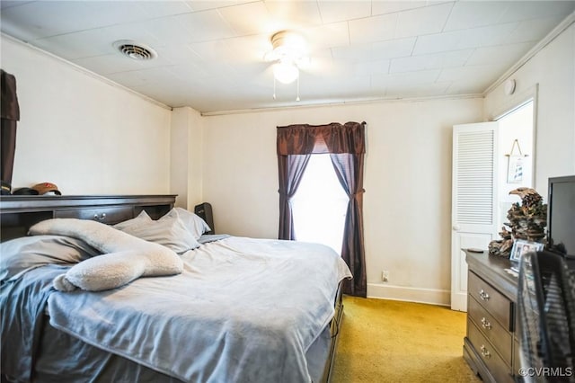 bedroom featuring light colored carpet and visible vents