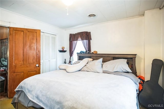 bedroom with a closet and visible vents