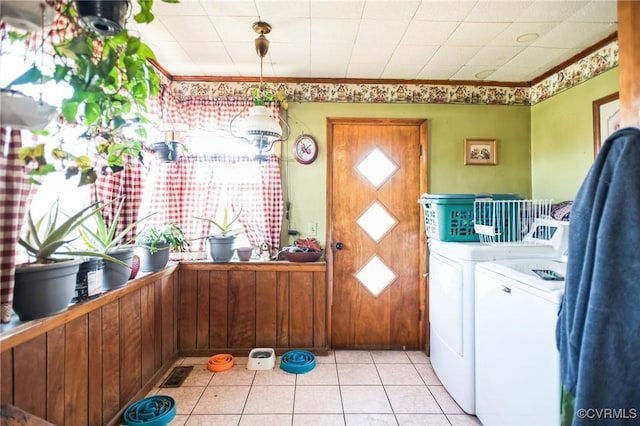 clothes washing area featuring laundry area, light tile patterned floors, visible vents, crown molding, and separate washer and dryer