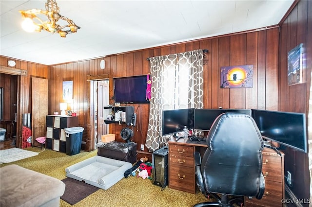 home office featuring carpet flooring and wood walls