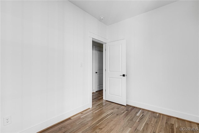 unfurnished room featuring light wood finished floors and baseboards