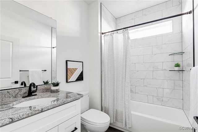 bathroom featuring toilet, shower / bath combo with shower curtain, and vanity