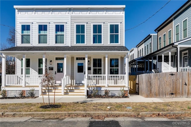 view of front of house with fence and a porch